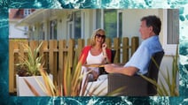 A couple enjoying the glorious sunshine on their balcony at Bembridge Coast, a Warner Hotel, bordered by the beautiful sea found nearby