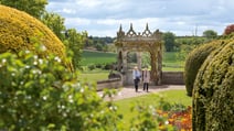 Two guests wandering through the beautiful gardens at Thoresby Hall Hotel