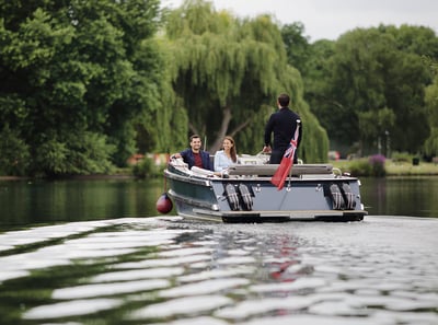 Two guests staying at The Runnymede on Thames enjoying a boat cruise along the River Thames