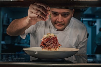 Chef adding final touches to a dish