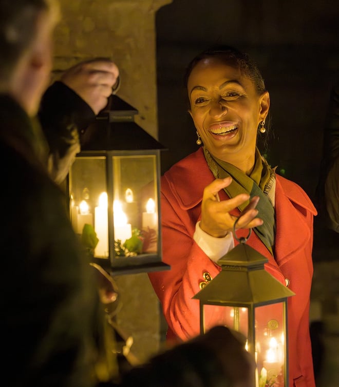 A guest holding a lantern during a lantern lit walk