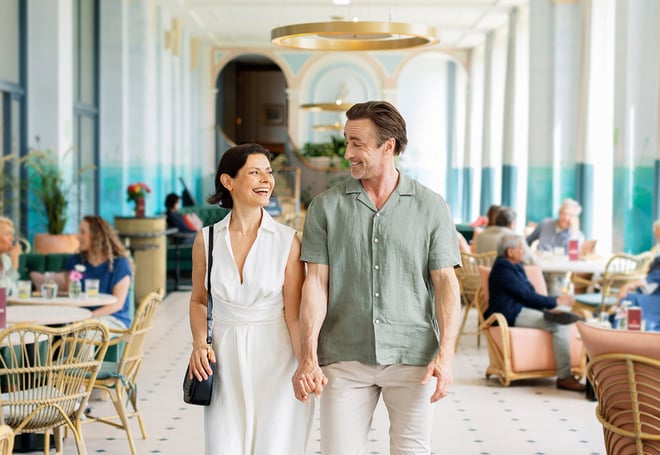 Angie and Mick walking through the Orangery at Heythrop Park